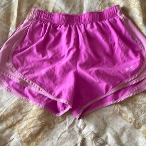 5 pairs of Nike dri-fit women’s shorts in various colors. All size medium.